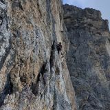 Caro climbing a few flakes, not all of which are solid