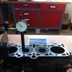 Engine reconditioning: measuring piston protrusion